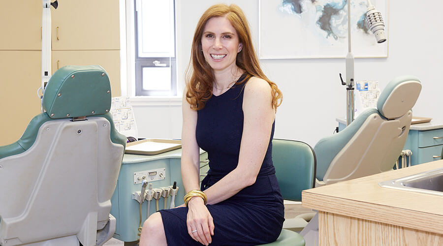 Dr. Emily Driesman sitting in the exam area and smiling