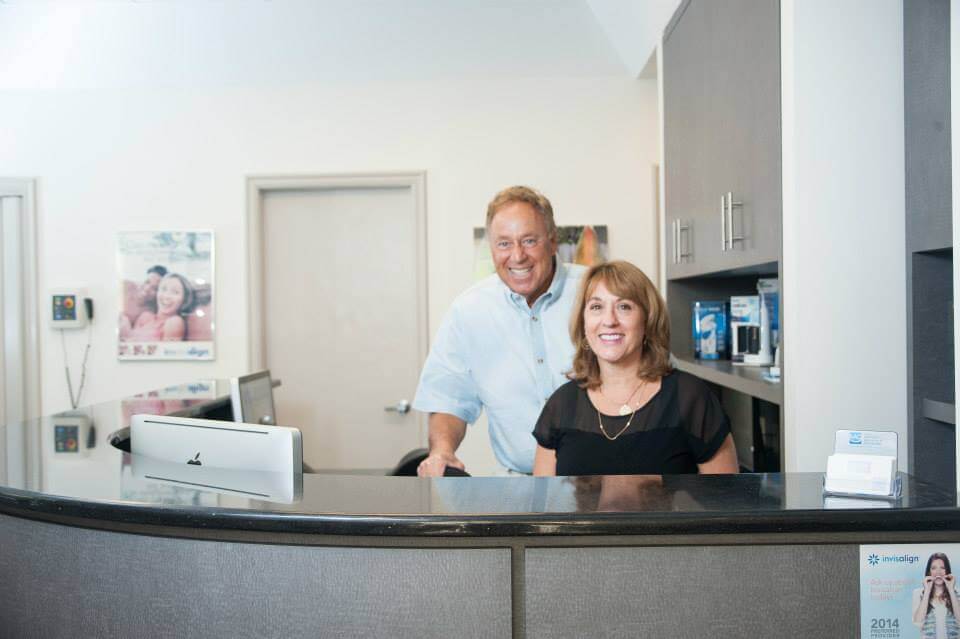 smiling orthodontic employees at front desk