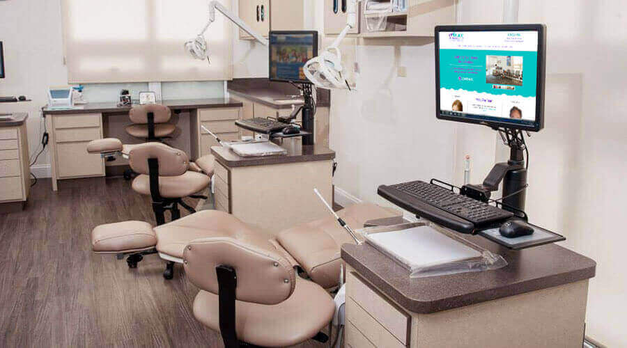 empty dental chairs with monitor screens